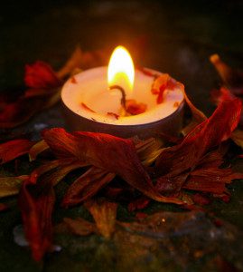 a lovely candle, surrounded by tons of tiny, flammable herbs waiting to become wax-soaked wicks! (Candle safety on pixiespocket.com)